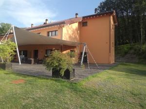 a house with a large deck in front of it at Hotel Bersè in Borgo Val di Taro