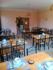 a dining room with wooden tables and chairs at Le Magiot in Montliot-et-Courcelles