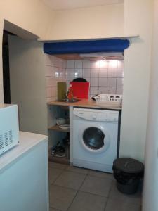 a laundry room with a washing machine and a counter at Alfama Fado Apartments in Lisbon
