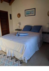 a large white bed with blue pillows in a bedroom at Simpson Bay Yatch Club 2 Bedrooms in Simpson Bay