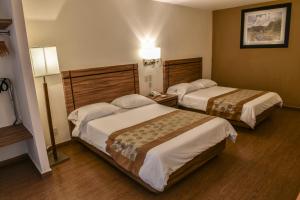 Postel nebo postele na pokoji v ubytování Hotel Oliver Inn - Business Class + 27 fotografií