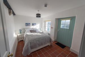 a bedroom with a bed and a green door at Fanad Lighthouse in Letterkenny