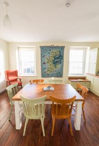 a dining room with a wooden table and chairs at Fanad Lighthouse in Letterkenny