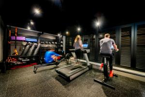 a man and a woman on exercise bikes in a gym at Manor House Lindley in Huddersfield