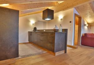 a kitchen with a counter and a couch in a room at Arvenhof in Serfaus +10 photos
