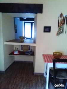 a small kitchen with a table and a window at Posada El Majuelo in Baños de la Encina +23 photos