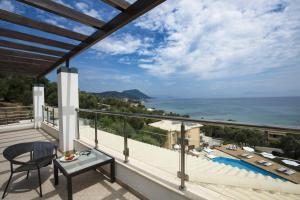 a balcony with a view of the ocean at Ionian Pearl Luxury Spa Villa in Mesongi