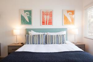 
a bed with a white bedspread and pillows on it at Surfhouse in Encinitas
