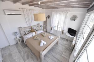 a bedroom with a bed with towels on it at Ftelia View in Elia