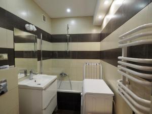 a bathroom with a sink and a toilet and a tub at Apartament Mazowiecka 125 in Krakow