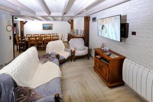 a living room with two couches and a table at Le Deroscope in Arrigny