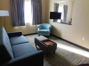 a living room with a couch and a chair at Island Suites in Lake Havasu City