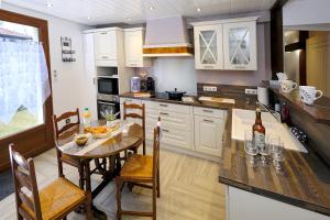 a kitchen with a table and a dining room at Le Deroscope in Arrigny