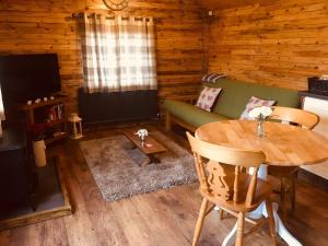 a living room with a table and a couch at Sunset Cabin in Mold