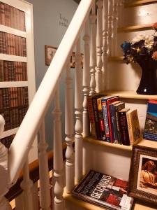 a staircase with a book shelf with books at Princess Anne Book Lovers Inn in Princess Anne