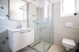 a bathroom with a shower with a toilet and a sink at Colic in Njivice +59 photos