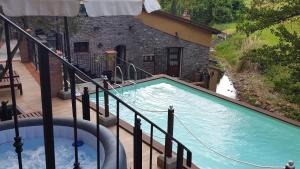 a swimming pool with a water slide next to a house at Camera Rosa in Borgo a Buggiano
