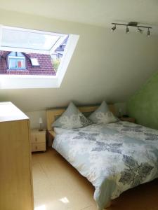 a bedroom with a bed and a skylight at Seeblick Imperia in Konstanz