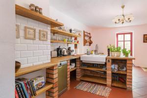 a kitchen with wooden shelves and a sink in a room at Rokitnica 37 in Niesulice