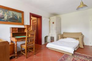 a bedroom with a bed and a desk and a piano at Rokitnica 37 in Niesulice