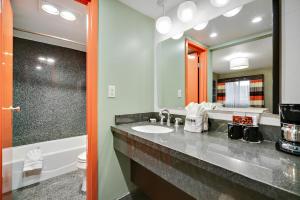 a bathroom with a sink and a toilet and a mirror at 3 Palms Hotel in Scottsdale
