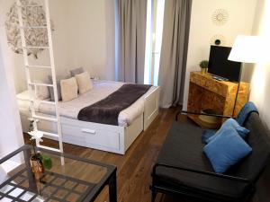 Habitación pequeña con cama y sofá en Apartment Gobernador - center, en Madrid