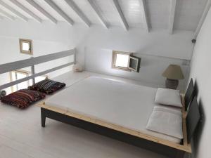 a bedroom with a large bed in a white room at Notus Villa in Chorto
