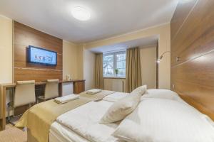 Łóżko lub łóżka w pokoju w obiekcie Pokoje gościnne Nord