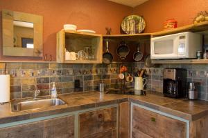 a kitchen with a sink and a microwave at Secluded 1 Bedroom Cabin on 50 Acres of Land in Panguitch