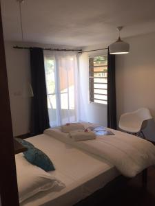 Schlafzimmer mit einem großen Bett und einem Fenster in der Unterkunft POÉ CÔTÉ LAGON in Bourail