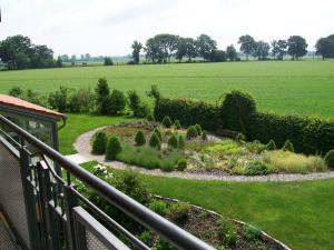 a view of a garden from the balcony of a house at Landhotel Larenzen in Kirchham