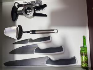 a set of knives sitting on a cutting board at close to beach and 15 mints to la rambla by tren in Sant Adria de Besos