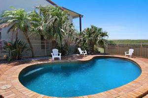 a small swimming pool with two chairs at Sunrise Reef 4 in Lennox Head