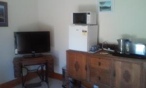 a room with a refrigerator and a television on a dresser at Marinavisage in Kettering