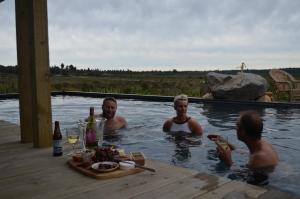 a group of people sitting in a swimming pool at Tongariro Springs Boutique Suites in National Park