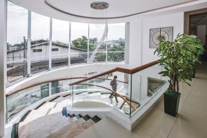 a person walking down a staircase in a building at The Azana Hotel Airport Semarang in Semarang