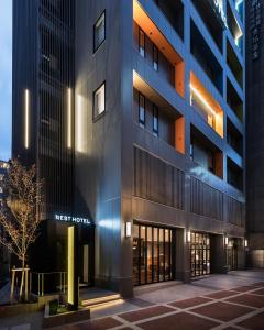 a facade of a building with a first hotel at Nest Hotel Osaka Umeda in Osaka