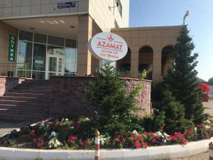 a awart convention center building with flowers in front of it at Azamat Hotel in Astana