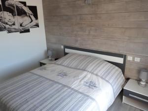 a bedroom with a bed with a wooden wall at La Fenière in Sault-de-Vaucluse +29 photos