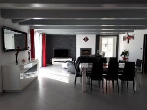 a living room with a dining room table and chairs at La Fenière in Sault-de-Vaucluse