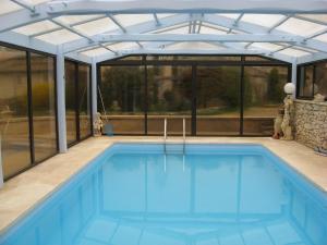 a swimming pool in a house with a glass roof at La Fenière in Sault-de-Vaucluse