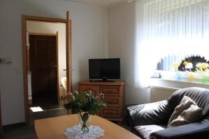 a living room with a vase of flowers on a table at Hintze in Soltau