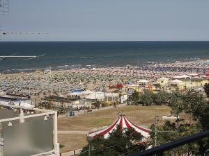 una spiaggia con tenda e una folla di persone di Hotel Telstar a Rimini