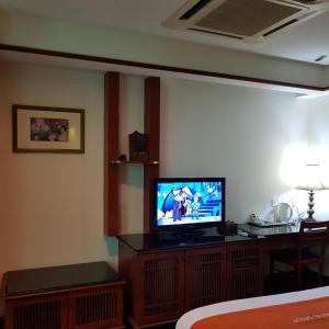 a hotel room with a television in a room at Tokido Private Water Chalet PD in Port Dickson