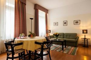 a living room with a table and a couch at Mondial Appartement Hotel in Vienna