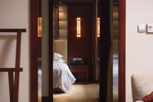 Postel nebo postele na pokoji v ubytování Zhejiang Xizi Hotel