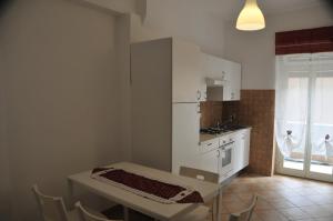 a kitchen with a table and a sink and a stove at RomAmoR in Rome