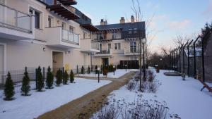 a building with snow in front of it at Apartament Lublin Centrum "Foxy Cat" in Lublin