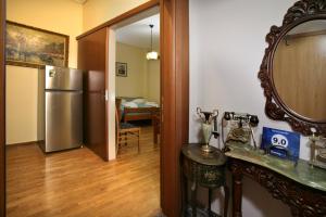 a kitchen with a refrigerator and a table and a mirror at Hotel Loutraki in Loutraki