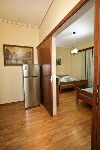 a kitchen with a refrigerator in the middle of a room at Hotel Loutraki in Loutraki